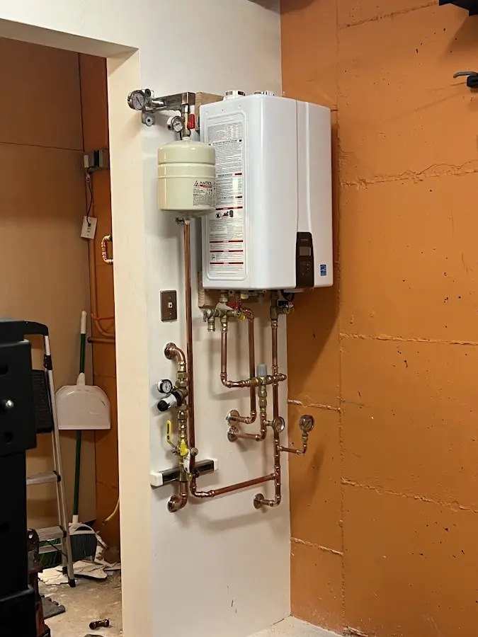 Plumbing technician inspecting water heater connections in Conway